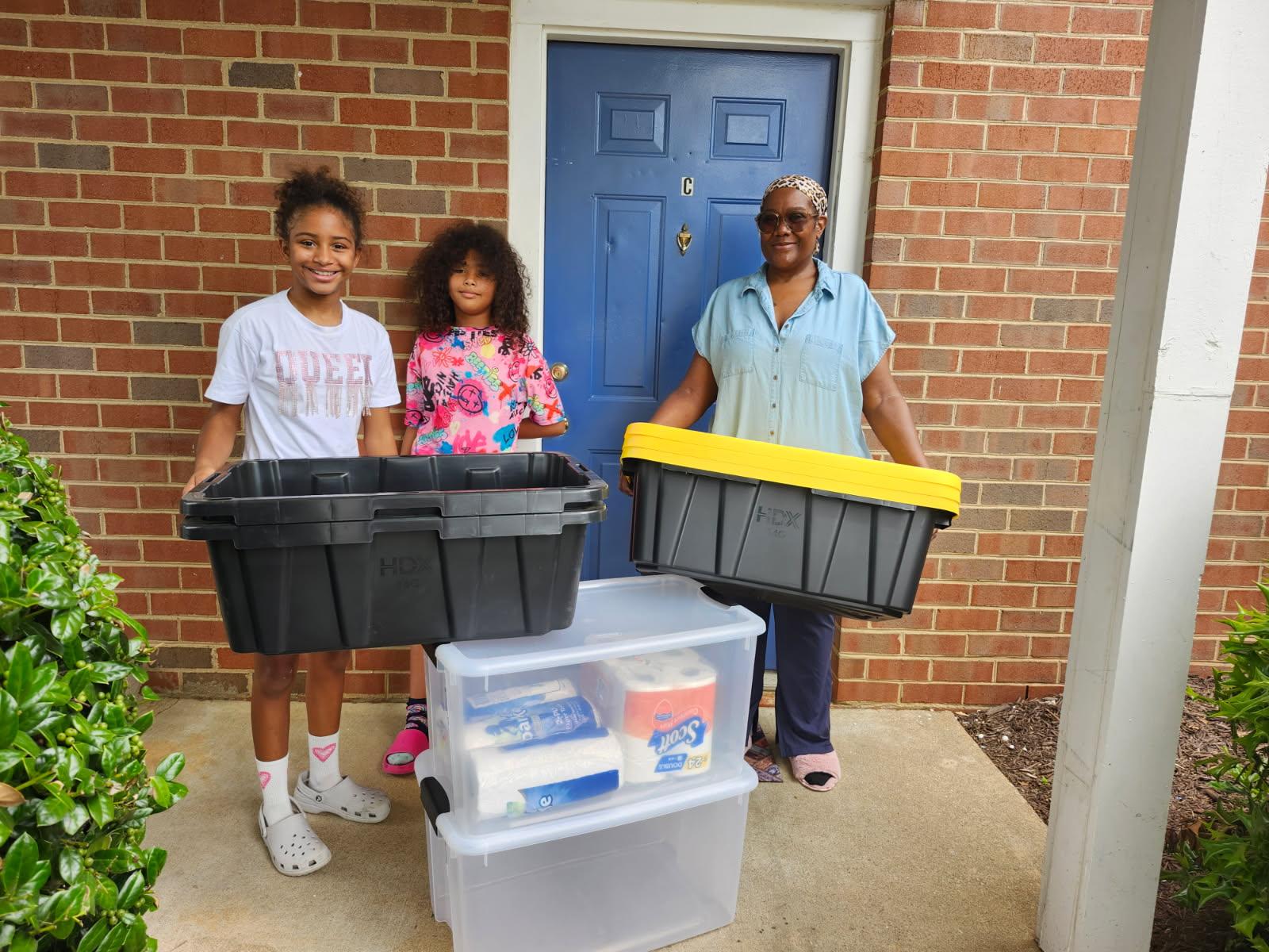 A family receiving supplies from Hope Outreach